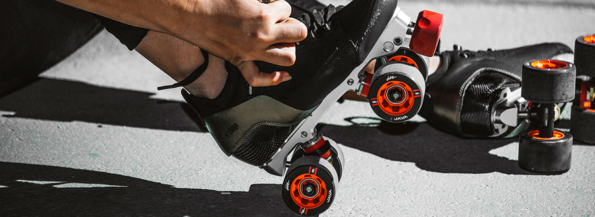 A person tying their Chaya roller skates