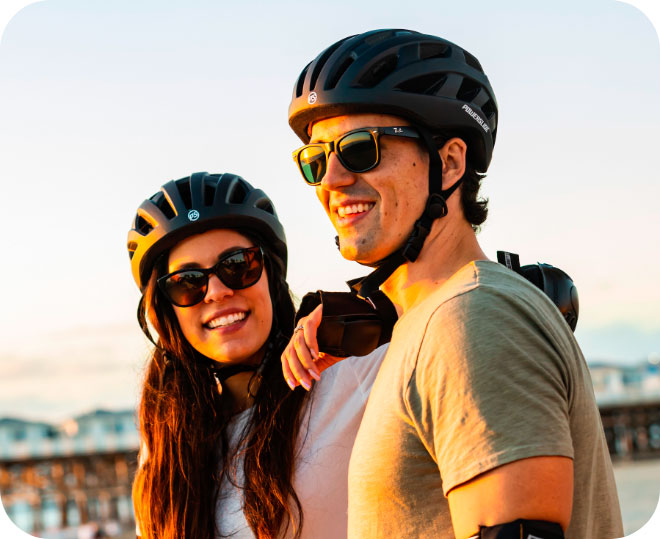 A male and female wearing Powerslide helmets and smile