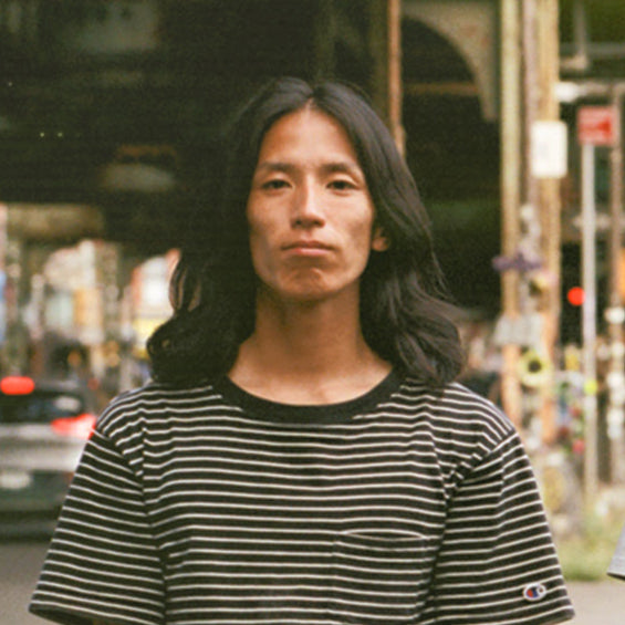 Three people standing together on a street with urban background