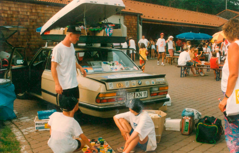 An image from the early 1990s of a large group of people and a car at an inline skating event