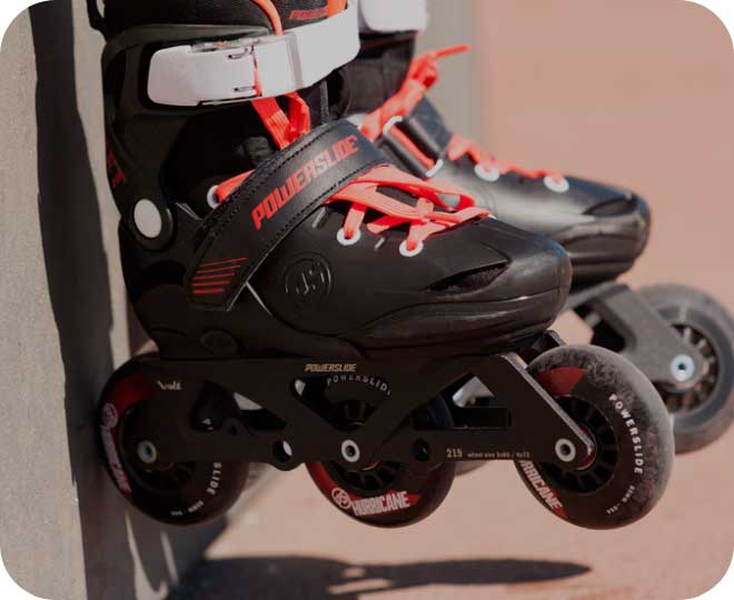 A close-up image of black three-wheel Powerslide Jet Pro inline skates