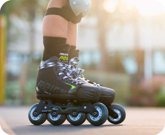 A close-up image of a Powerslide Reign inline hockey skates with laces wrapped around the ankles