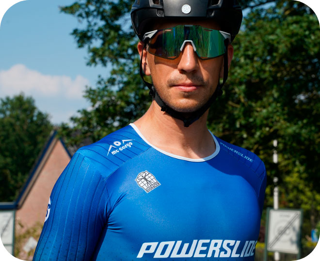 Professional online speed skater Felix Rijhen wearing a helmet and sunglasses on looks toward the camera