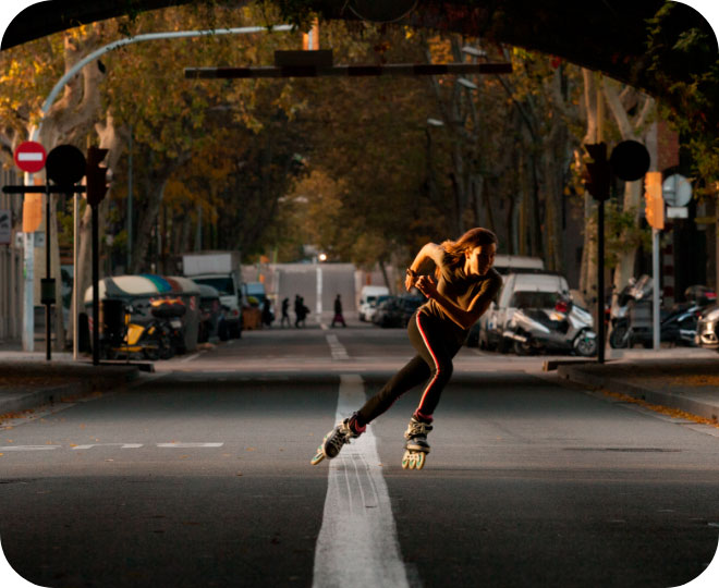 A female wearing Powerslide 3-wheel inline skates in an urban setting